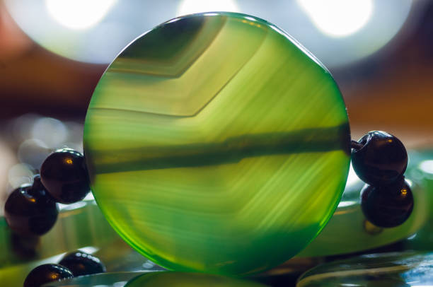 istock Large polished beads of beautiful translucent green agate gemstone, macro 1126125480