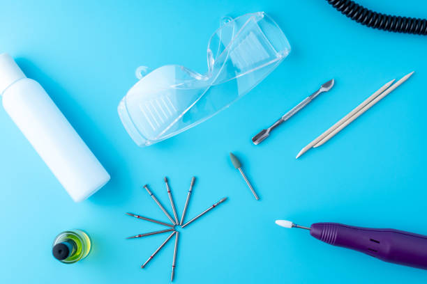 istock Set of cosmetic tools for professional hardware manicure on a blue background. Milling cutter, glasses, top view 1126125539