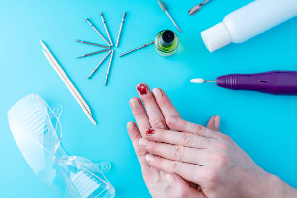 istock Tools for professional hardware manicure and women's hands on blue background 1126125574
