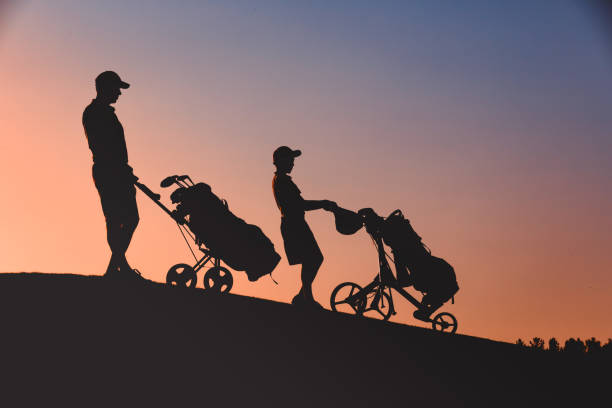 istock man with his son golfers silhouette 1126125709