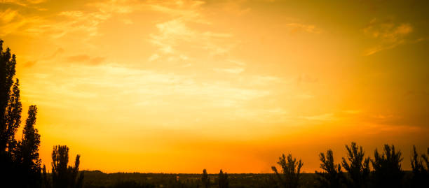 Landscape with dramatic light - beautiful golden sunset with saturated sky and clouds, peaceful nature serene background.