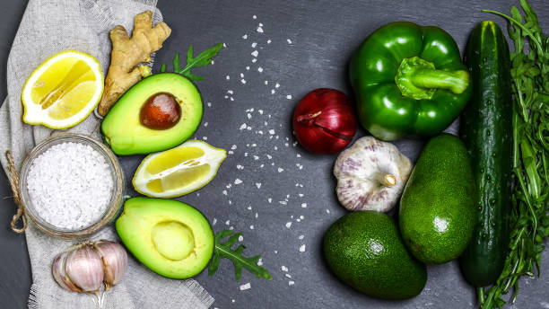 istock Background with assorted green vegetables on a grey stone background. Healthy food concept with copy space 1126130478