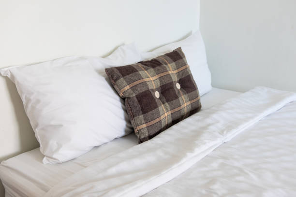 istock Elegant bed with soft white duvet, bedding and pillows. Bed made-up with clean white pillows and bed sheets in beauty room. Comfortable white bed in the room 1126132119