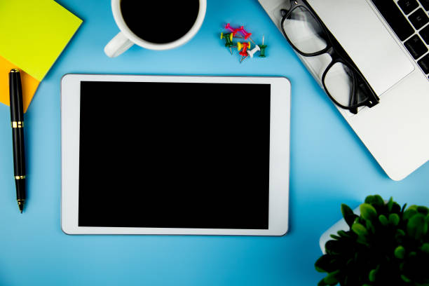 istock top view with blank mock up tablet on Office desk working space. 1126133672