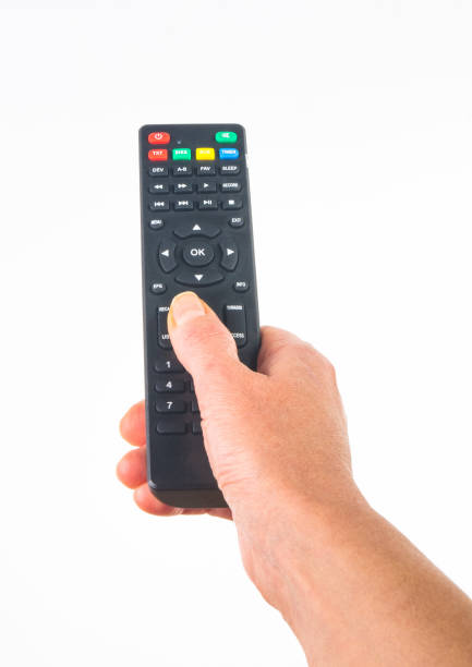 istock hand holding a remote control on white background, close-up 1126133899