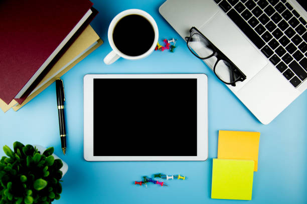 istock top view with blank mock up tablet on Office desk working space. 1126134268