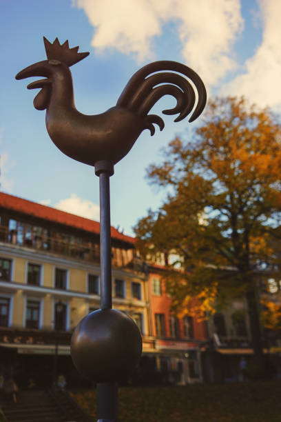 Weathervane in the form of a metal cockerel on the Dome Square in Riga on a sunny autumn day