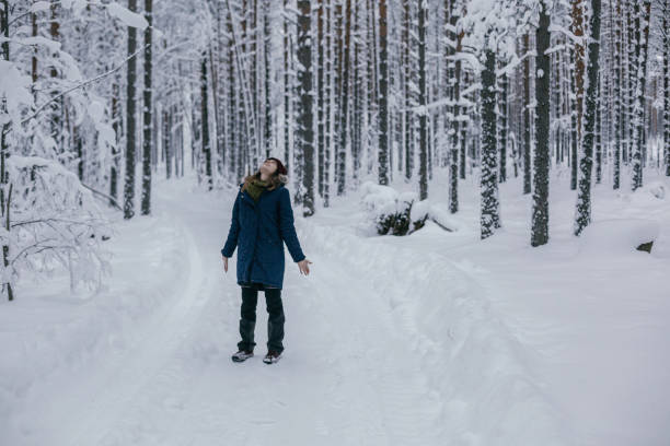 istock girl walks in the winter forest 1126135770