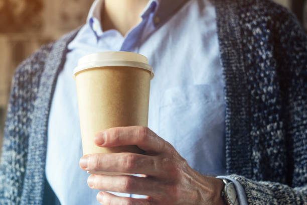 istock Office worker is holding a cup of coffee. Coffee business concept 1126136342