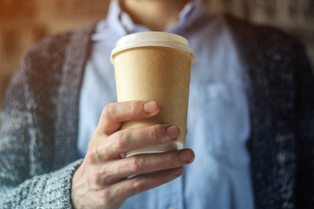 istock Office worker is holding a cup of coffee. Coffee break concept 1126136443