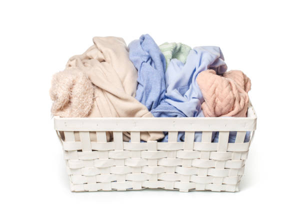 istock Clothes in a laundry wooden basket isolated on white background 1126138138