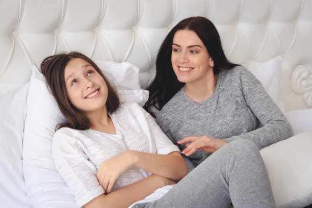 istock Beautiful mother and her cute daughter talking each other 1126138445