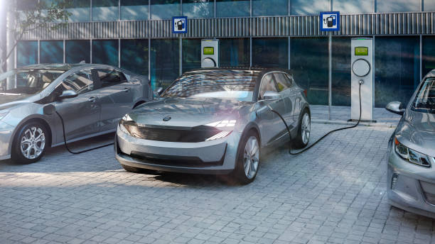 electric suv of the future charging electricity with public charger electric suv of the future charging electricity with public charger ev charging stock pictures, royalty-free photos & images