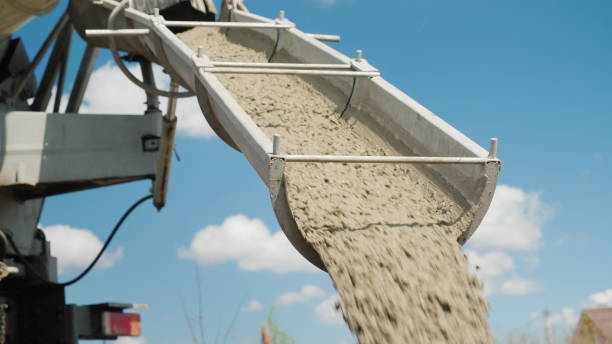 Cement on the troughs follows from the concrete mixer. Delivery of ready-made high-quality concrete concept stock photo