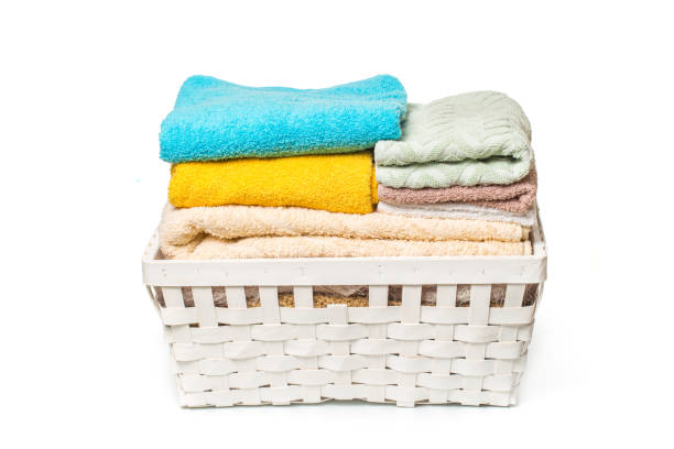 istock Clothes in a laundry wooden basket isolated on white background 1126140724