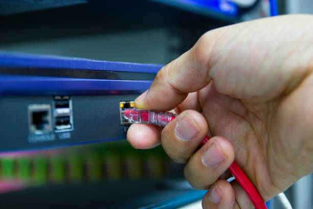 istock Hand of man holding The network cables to connect SFP module port 1126141244