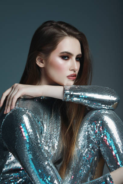 istock Beautiful young woman in sequin jumpsuit 1126142507