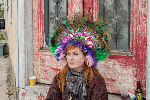 A woman wearing costumes in the street during the Mardi Gras celebration at New Orleans Carnival, Louisiana, USA  The Mardi Gras is a great event held in New Orleans and it is visited yearly by thousands of tourists from all over the world.