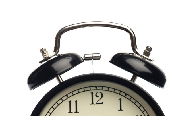istock Black retro alarm clock on isolated background,close up 1126142652