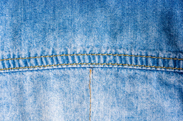 istock Blue washed faded jeans texture with seams 1126144553