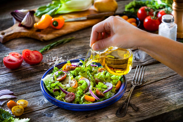 istock Dressing fresh organic vegetables salad with olive oil 1126147089