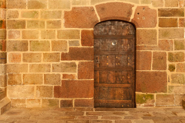 Door in the stone wall inside Mont Saint-Michel abbey, Normandy coast, France
