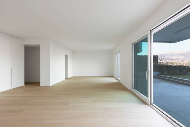 istock Modern living room with white walls, parquet and windows 1126148012
