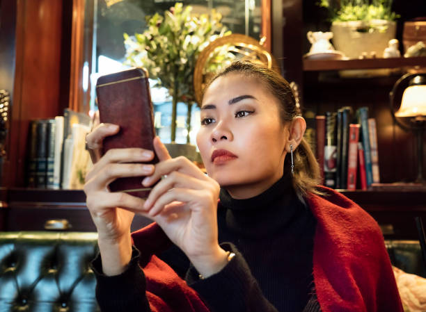 istock Woman using mobile phone in a luxurious restaurant 1126148431