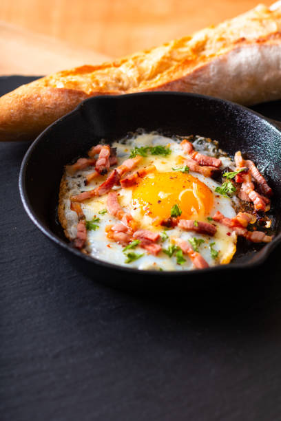 istock Food concept Fried egg and cheese bacon in cast iron skillet with copy space 1126148647