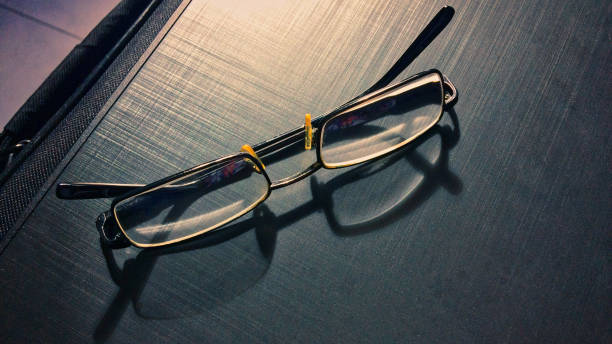 istock glasses on a dark background, shadow of the rim, metallic material 1126149449