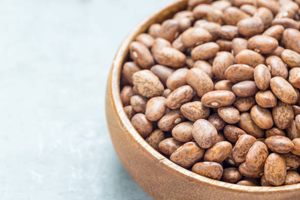 istock Dry pinto beans in wooden bowl, copy space, horizontal 1126149925