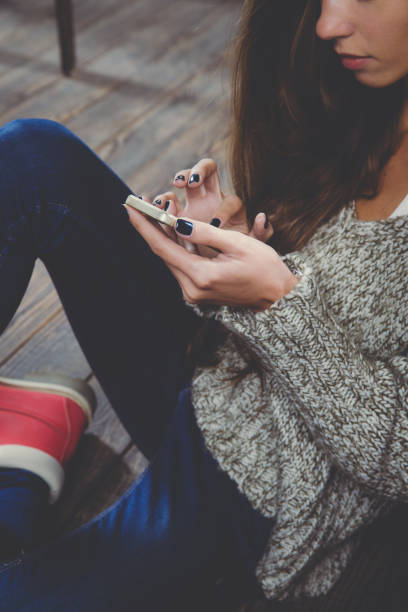 istock woman using smartphone. Relax time during cold weather 1126150440