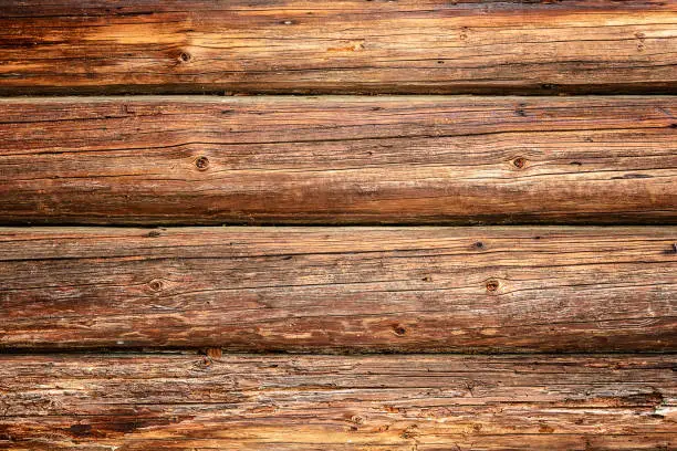 Photo of Magnificent background of a textured old wall made of brown wooden beams