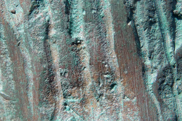 Textural background surface of a copper surface with green oxidized parts