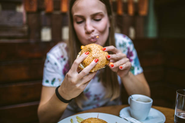 Woman eating Delicious Burger