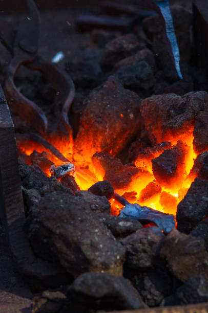 istock blacksmith furnace with burning coals, tools, and glowing hot metal workpieces 1126156639