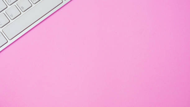 istock Keyboard of a computer on pink background 1126157011