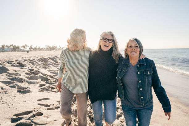 istock Three Senior women walking on the beach 1126160327