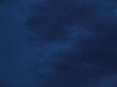 Cloudy nighttime sky in shades of midnight blue to royal blue