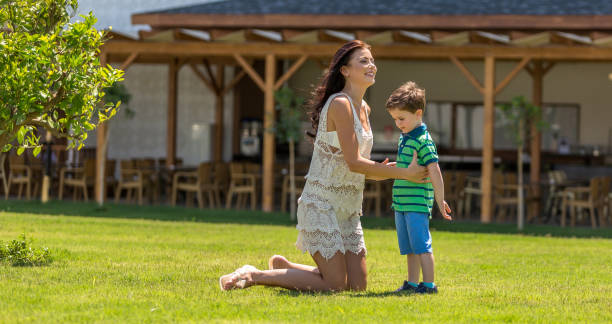 istock Happy mother and son in resort backyard 1126163161