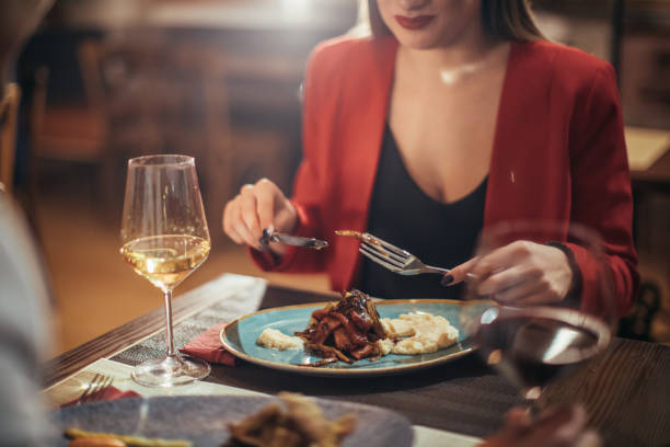 istock Woman eating dinner on date in restaurant 1126164348