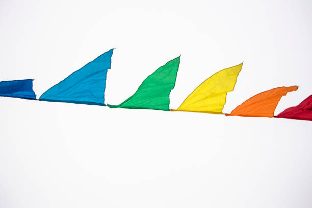 istock Colorful multicolored triangular flags, isolated on a white background, hang on a rope and flutter in the wind. Holiday decoration, carnival, festival 1126166143