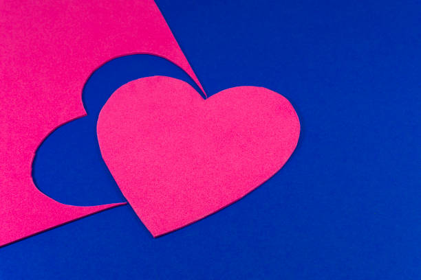istock Hearts cut out of bright color foam sheets on blue 1126167951