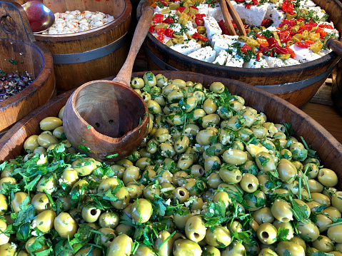 Big tub of olives on a market stall. Portobello Road in London, England.