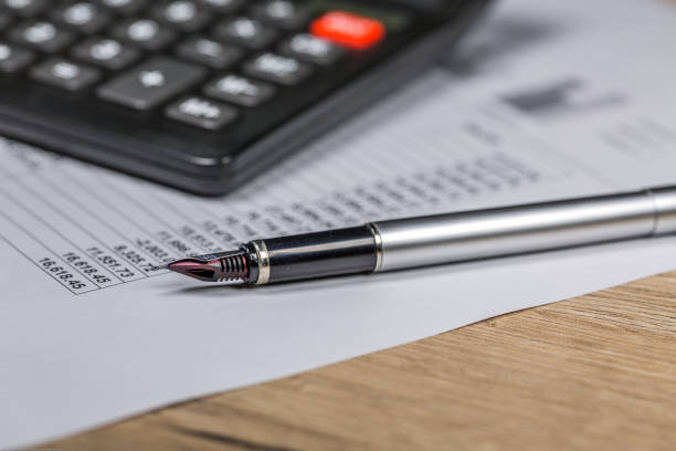 istock Fountain Pen and Calculator Lie on Business Signature Contract Document 1126169200