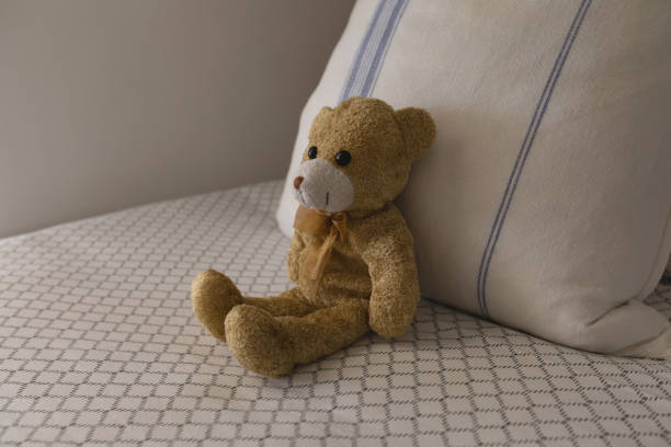 istock Teddy bear on a bed in bedroom at home 1126171327