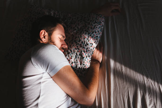 istock Young man sleeping in the bed in the morning 1126173052