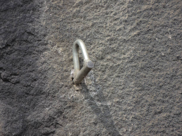istock Climbing bolt stuck in rock wall. 1126176036