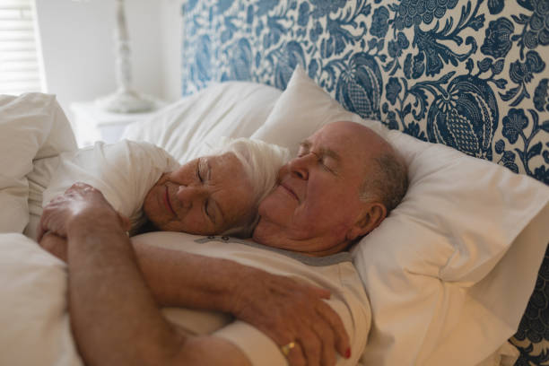 istock Senior couple sleeping together in bedroom 1126177310