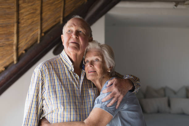 istock Senior couple embracing each other at home 1126180343